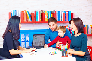 Parents and child with advisor and computer