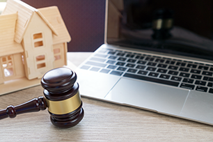 Picture of a house, compuer and gavel.